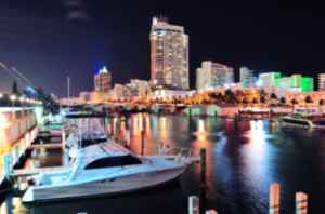 Weekly yacht rental Miami by Yacht Scarlet Charters luxury yacht docked in Miami marina at night